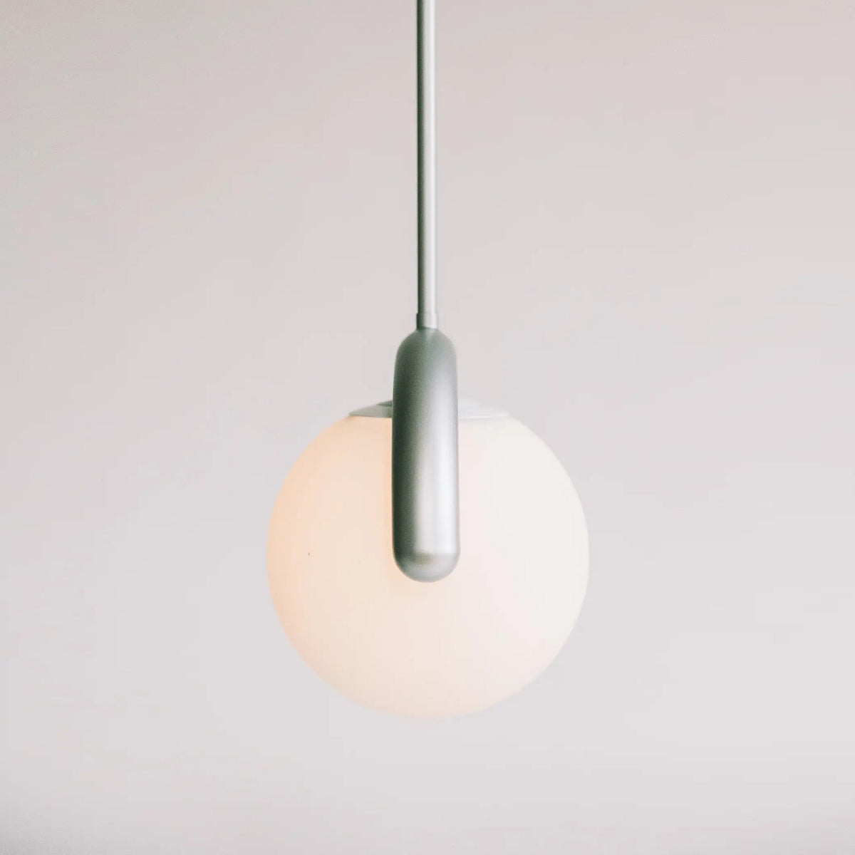 Modern Linear Chandelier with Curved Metal Frame & Glass Sphere – Art Nouveau Pendant Light for Dining Room
