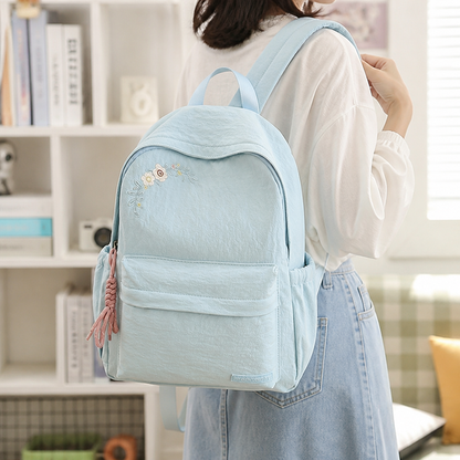Mochila escolar con bordado floral y múltiples bolsillos