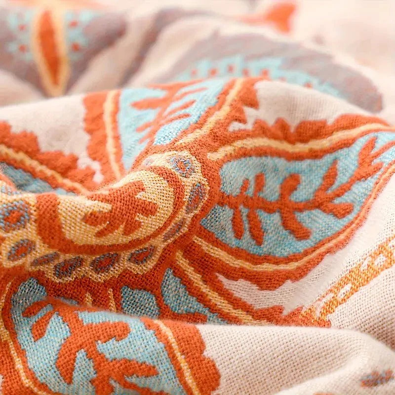 Manta floral colorida con ribete de borlas bohemias